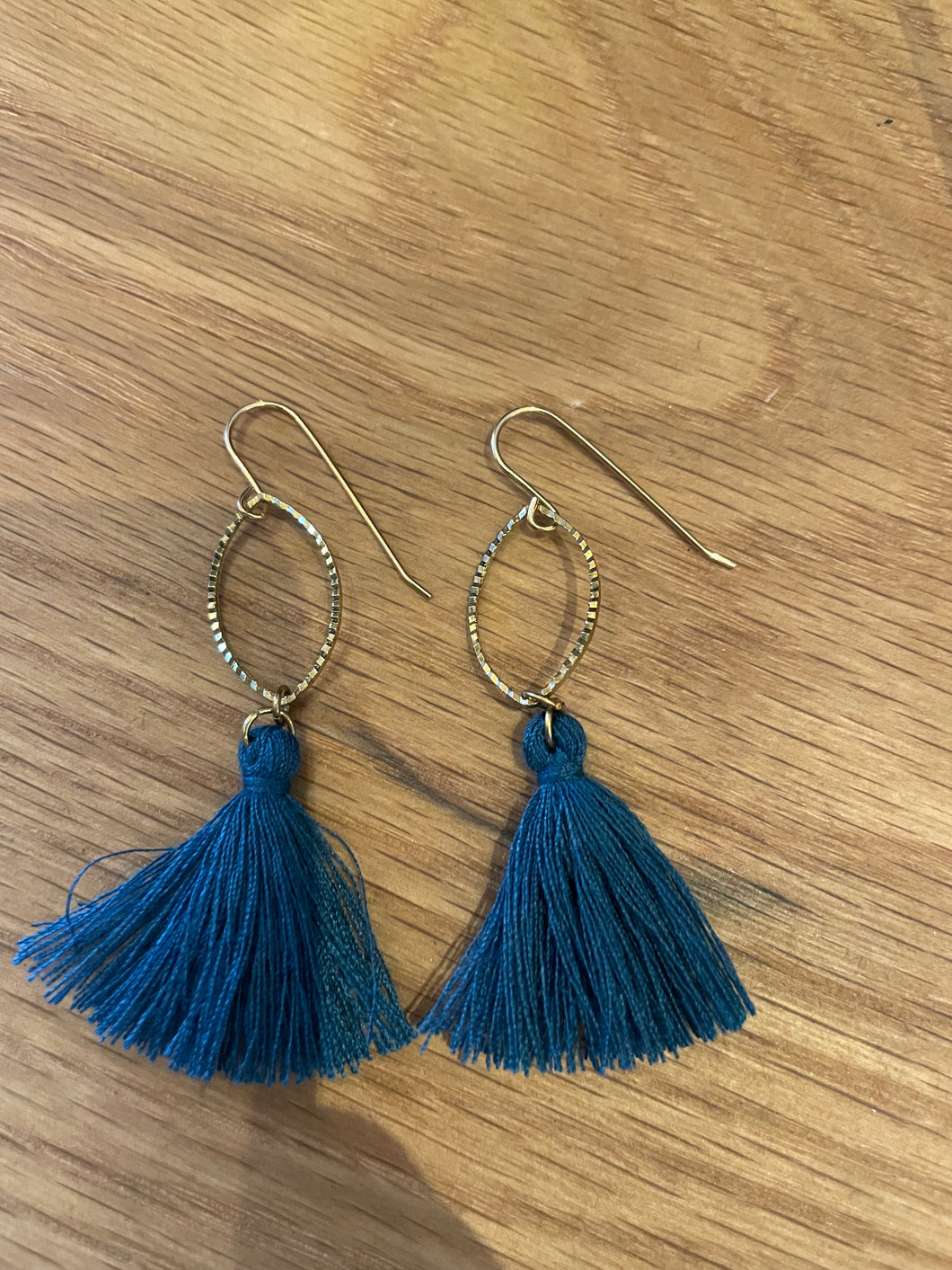 Gold earrings with blue tassel